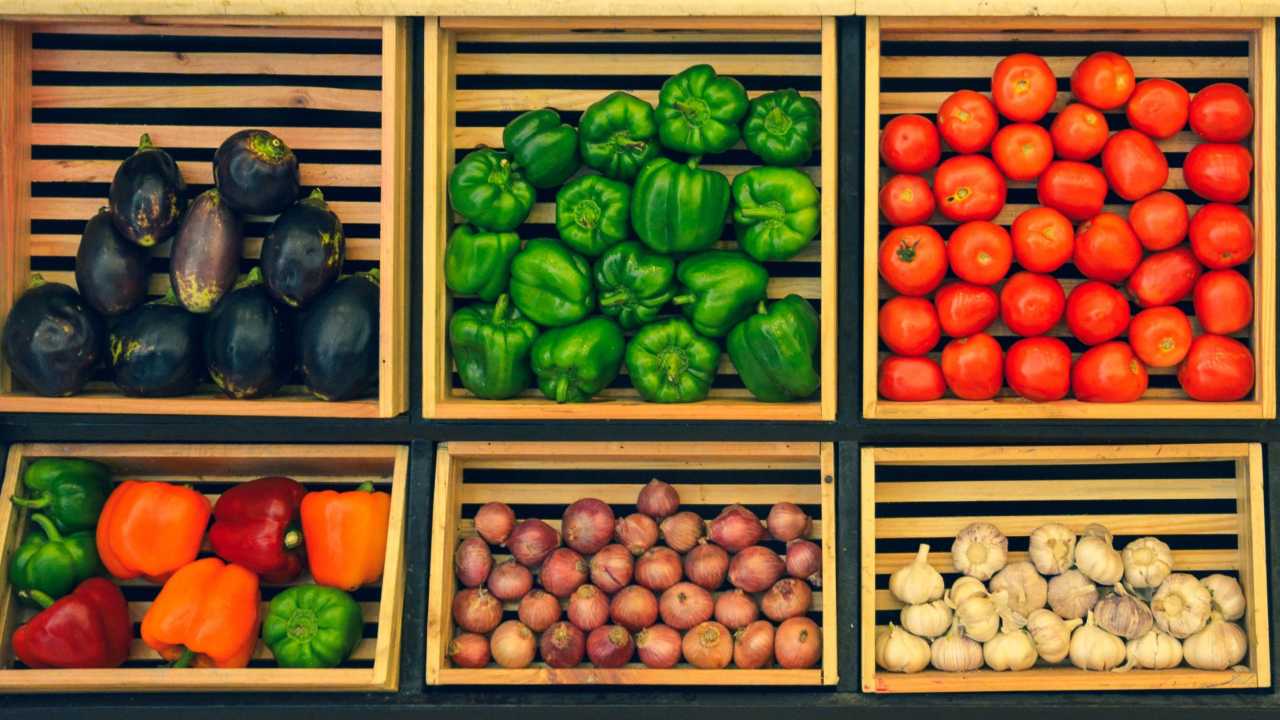 Baskets of colorful vegetables for sale.