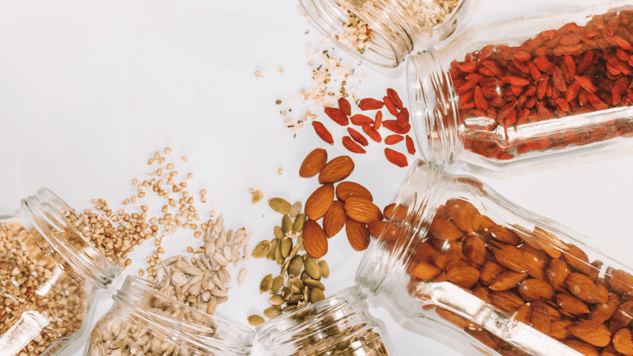 Clear jars of nuts and seeds.